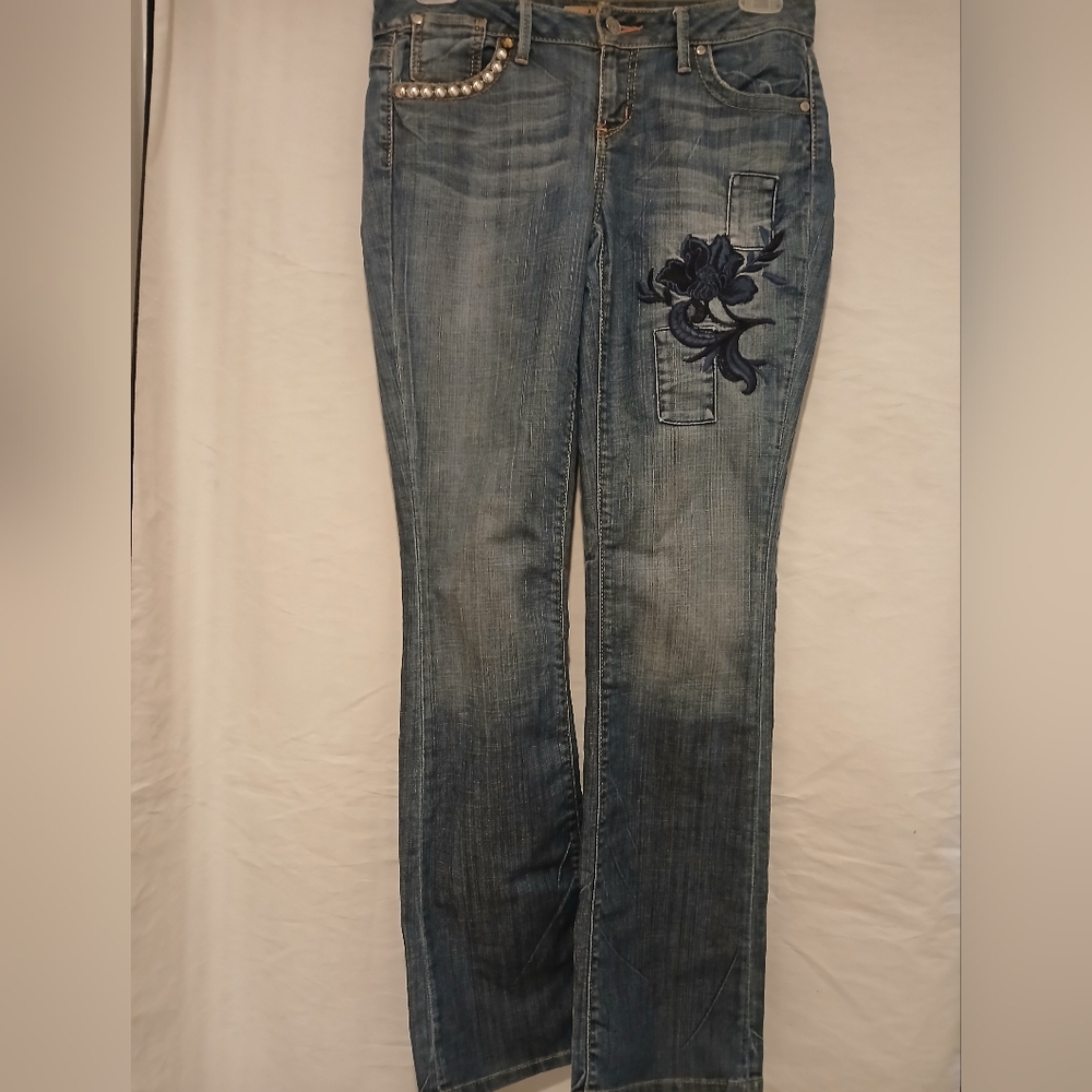Hippie Blue Denim Jean With Flower Embroidery And Studded Pocket.